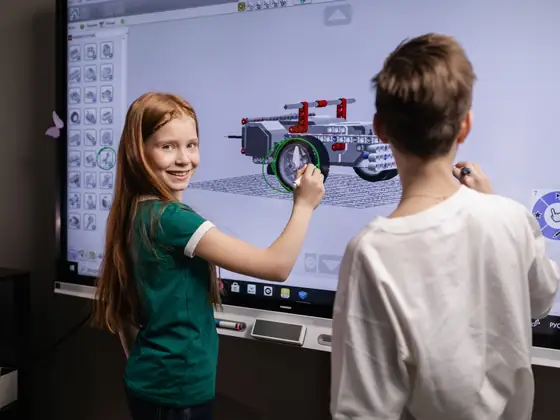 Two children working out a sequence on an interactive board